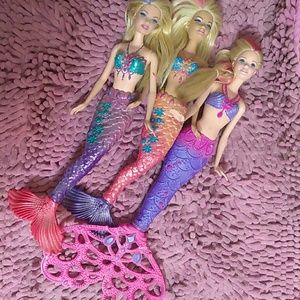 Three Barbie mermaids! Pink and purple streaks.